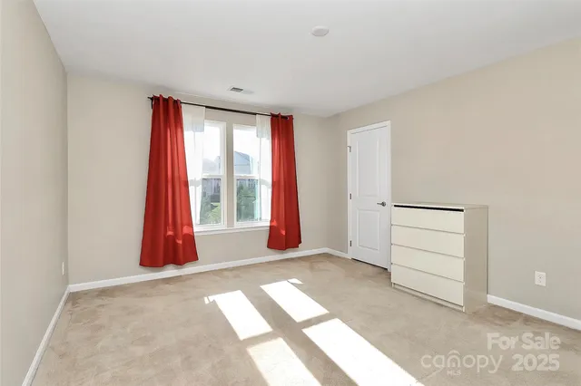 a view of a room with window and air conditioner