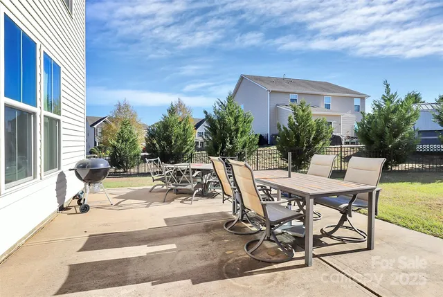 a view of a patio with table and chairs and potted plants