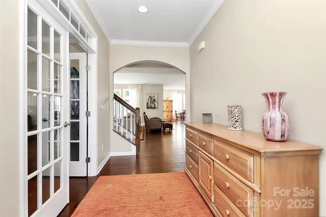 a hallway with a dining table and chairs