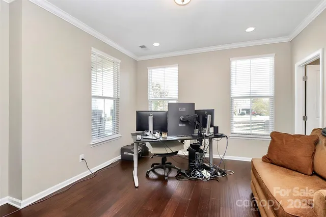 a view of a livingroom with workspace and a window