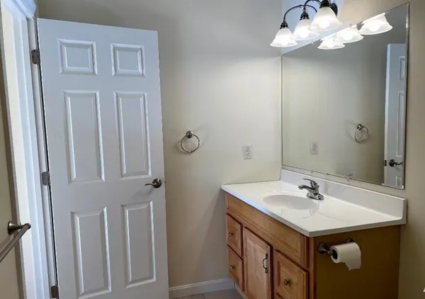 a bathroom with a sink vanity and a mirror
