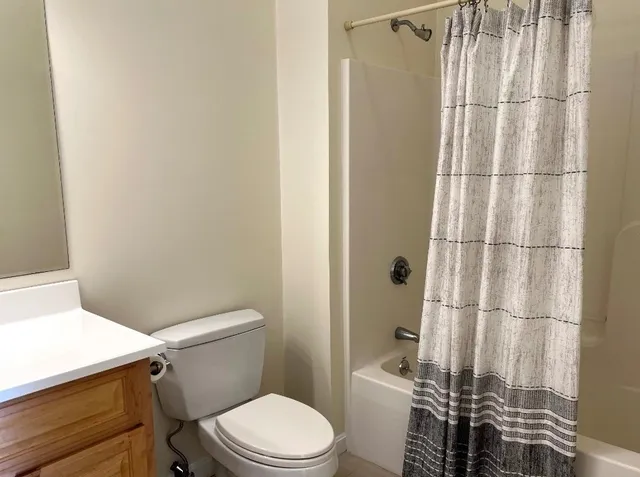 a white toilet sitting next to a bathroom sink