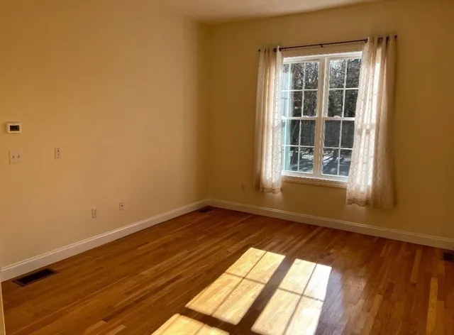 a view of an empty room and a window