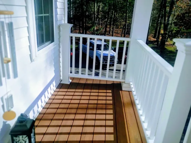 a view of staircase with lots of stuff and hardwood floor
