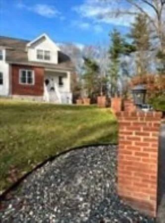 a front view of a house with a garden