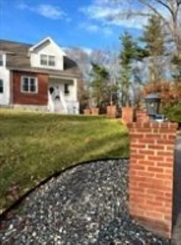 a front view of a house with a garden