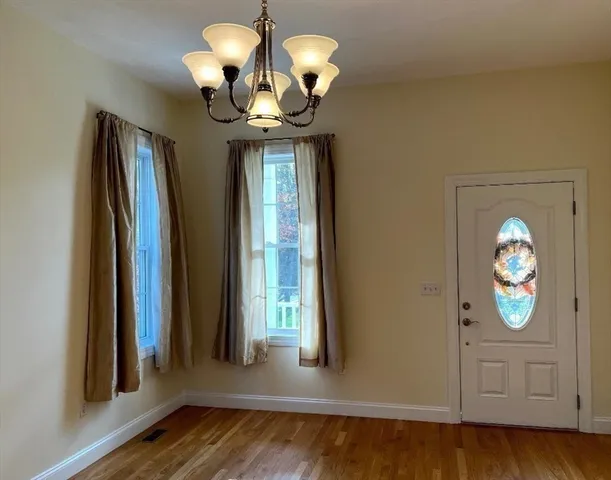 a view of a chandelier fan and wooden floor