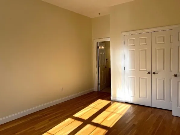 a view of an empty room and wooden floor