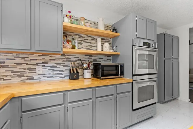 a kitchen with stainless steel appliances granite countertop a stove and a refrigerator