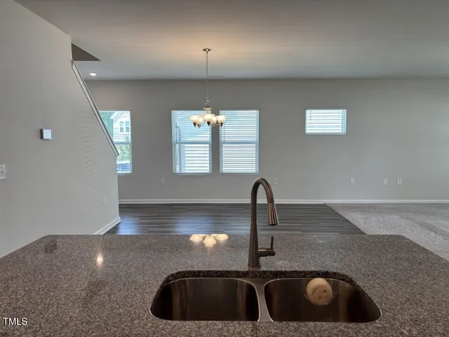 a view of kitchen with cabinets and wooden floor