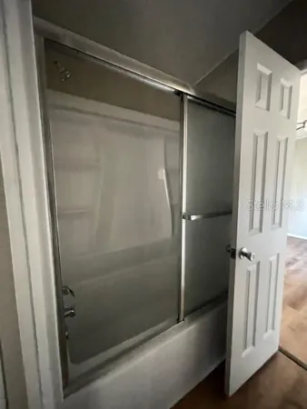a bathroom with a glass shower door