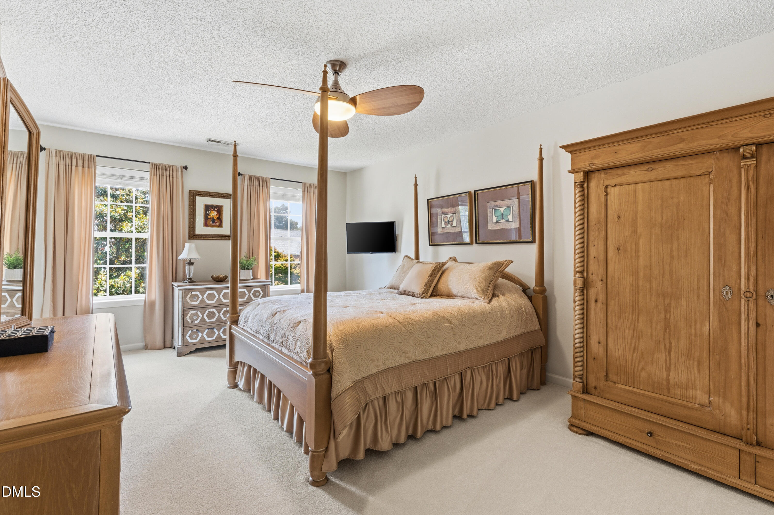 1211 Waterford Green Drive Apex, NC 27502 - Photo 30 of 53 a bed room with a bed and a chandelier