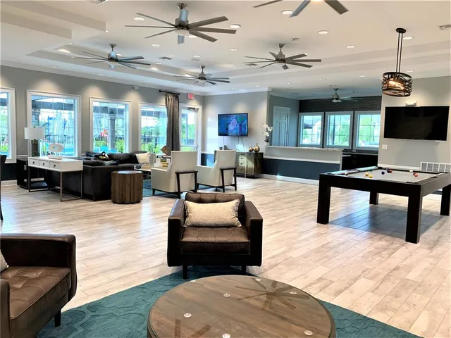 a room with furniture a large window and a chandelier