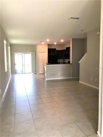 a kitchen with granite countertop a refrigerator and a sink