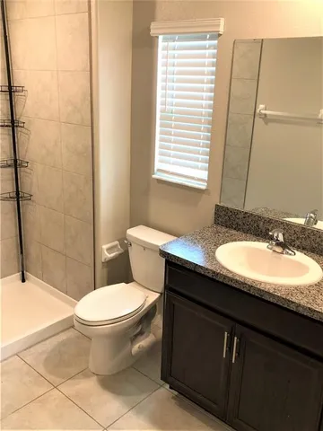 a white toilet sitting next to a bath tub