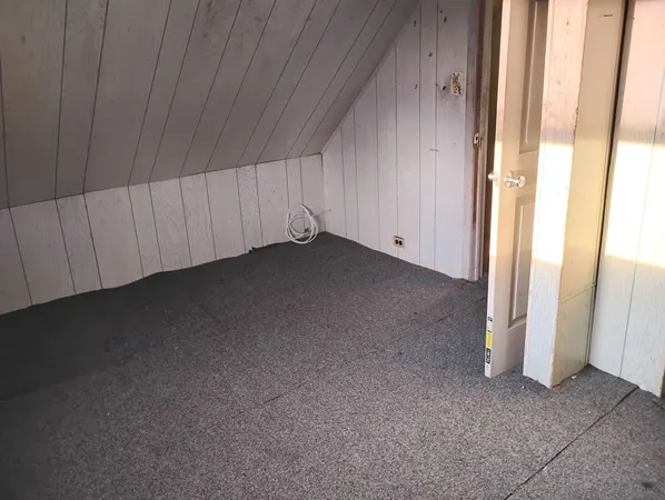 a view of a hallway with wooden shelves