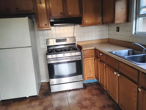 a kitchen with a stove top oven and sink