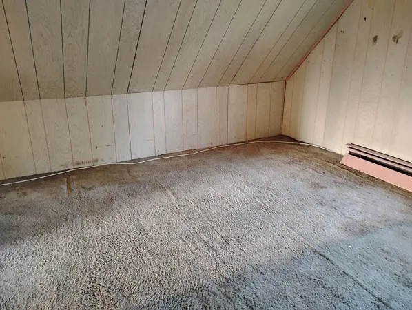 a view of a livingroom with an empty space and wooden floor