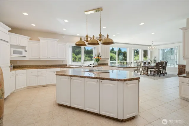 a kitchen with counter top space and windows