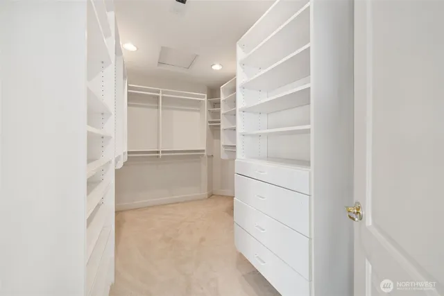 a view of walk in closet with empty racks