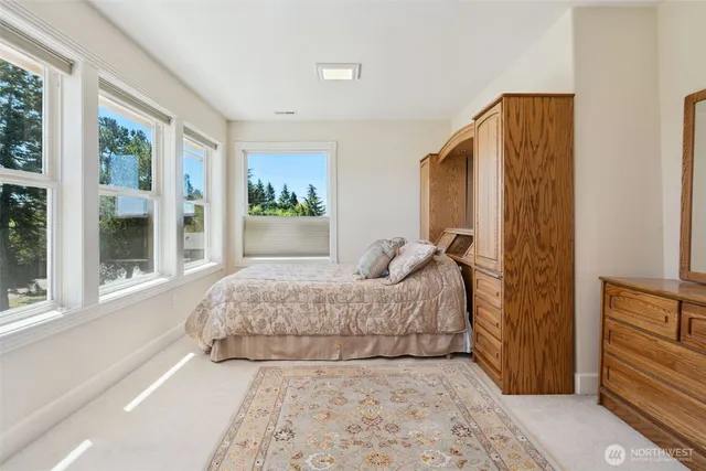 a spacious bedroom with a bed and a window