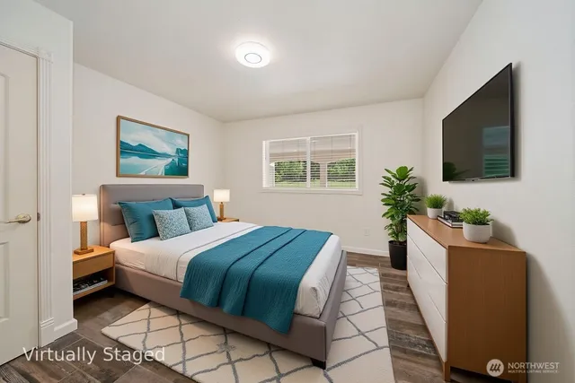 a bedroom with a large bed and a flat screen tv