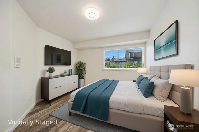 a bedroom with a bed and a flat screen tv