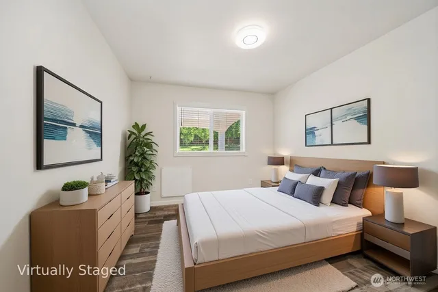 a bed room with a bed and a potted plant