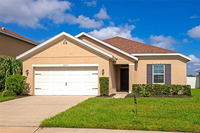 a view of a house with backyard