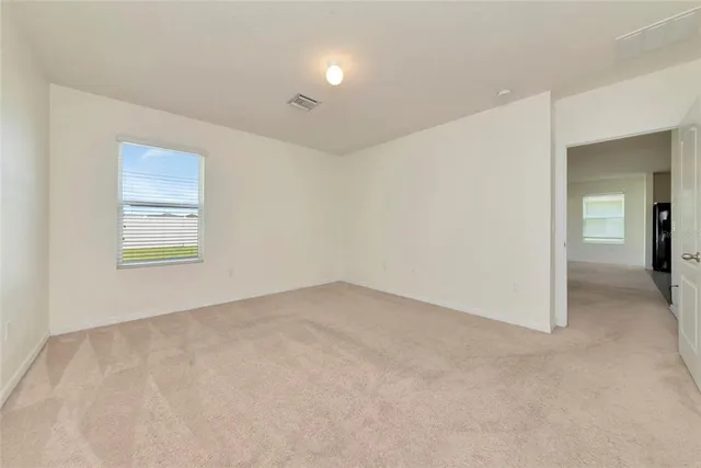 an empty room with windows and closet