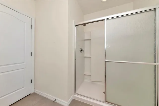 a bathroom with a glass shower door
