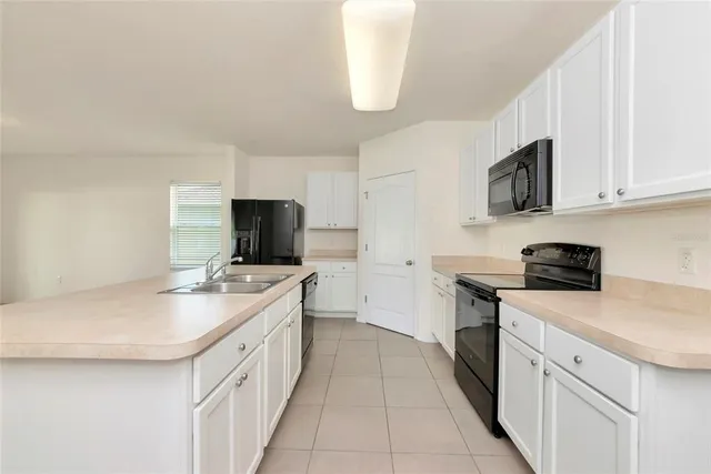 a kitchen with a stove top oven sink and cabinets