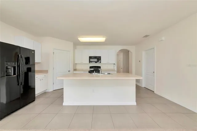 a view of kitchen with stainless steel appliances a refrigerator and a stove