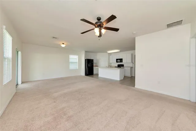a view of a livingroom with a kitchen