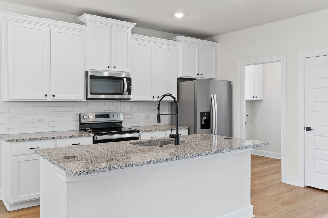 9509 Demure Drive, Unit 4 Manor, TX 78653 - Photo 4 of 21 a kitchen with granite countertop a refrigerator and a sink