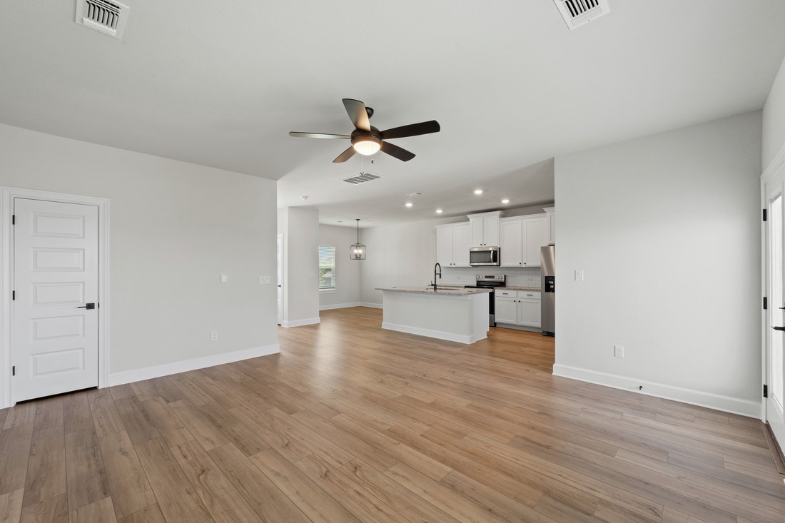 9509 Demure Drive, Unit 4 Manor, TX 78653 - Photo 7 of 21 a view of kitchen with wooden floor and a ceiling fan