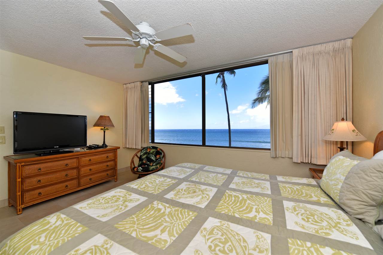 3543 Lower Honoapiilani Road, Unit L302 Lahaina, HI 96761 - Photo 15 of 28 a bedroom with a bed and a flat tv screen on dresser