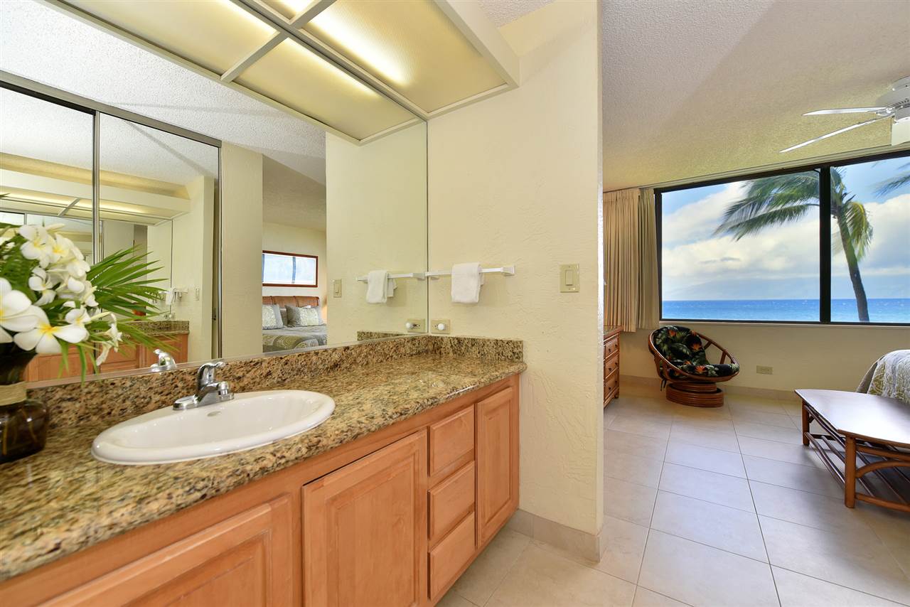 3543 Lower Honoapiilani Road, Unit L302 Lahaina, HI 96761 - Photo 17 of 28 a bathroom with a granite countertop sink and a mirror