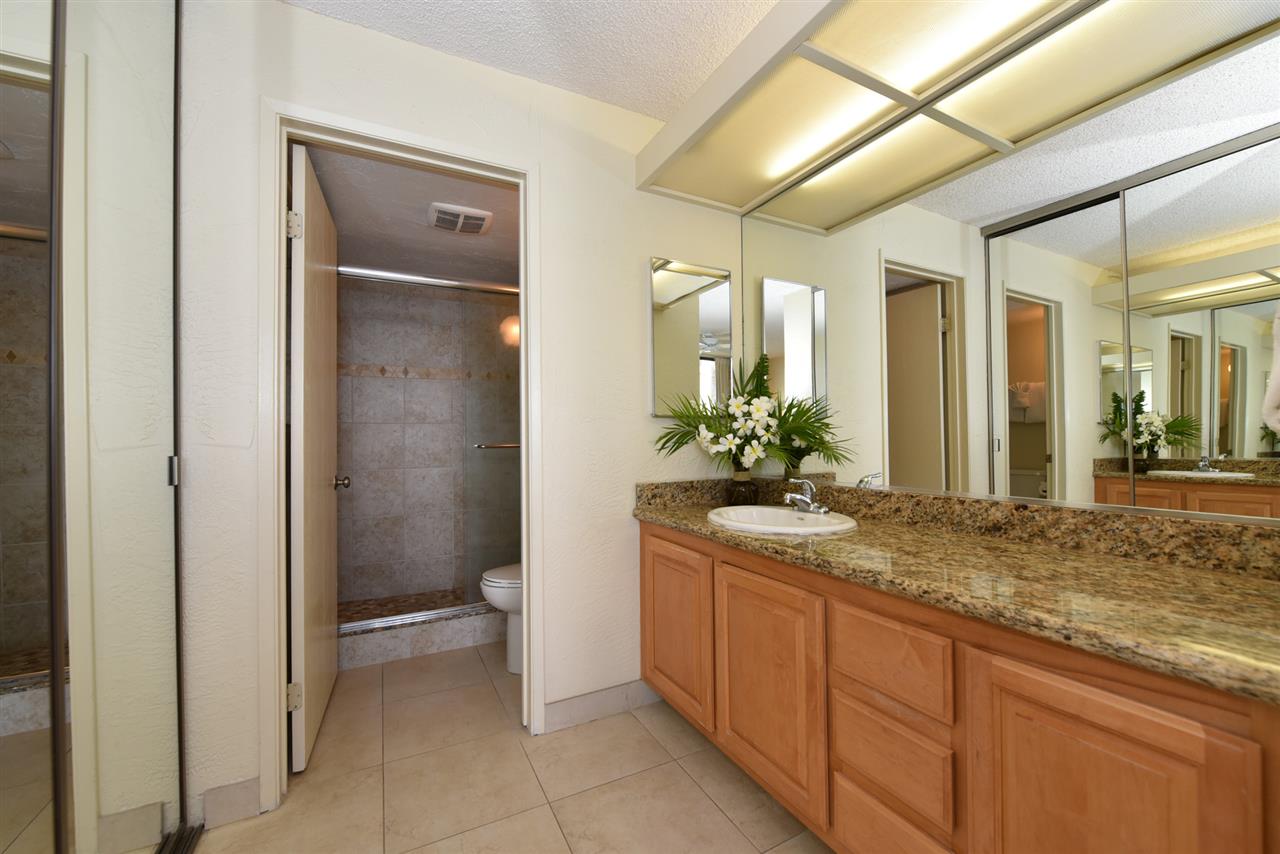 3543 Lower Honoapiilani Road, Unit L302 Lahaina, HI 96761 - Photo 18 of 28 a bathroom with a granite countertop sink a toilet and shower