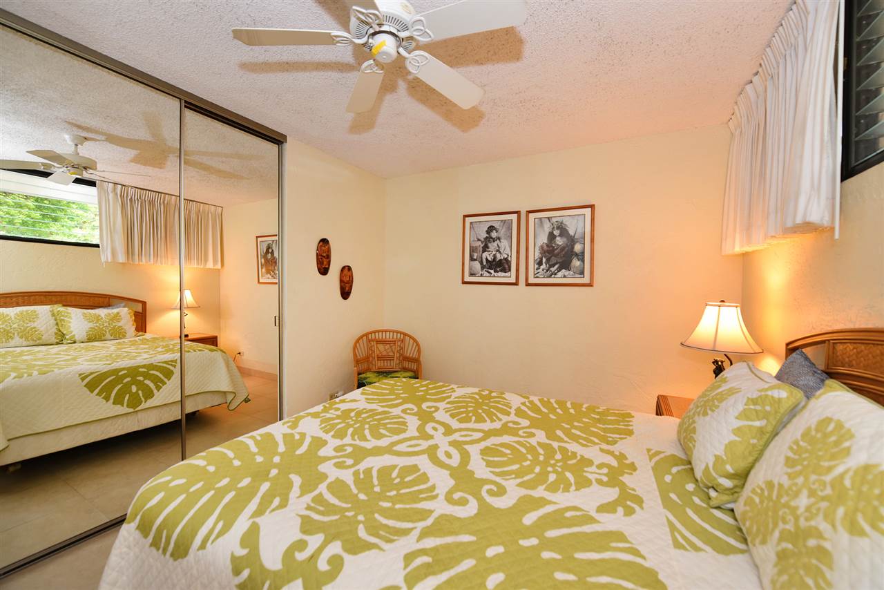 3543 Lower Honoapiilani Road, Unit L302 Lahaina, HI 96761 - Photo 20 of 28 a bedroom with a bed and a chandelier