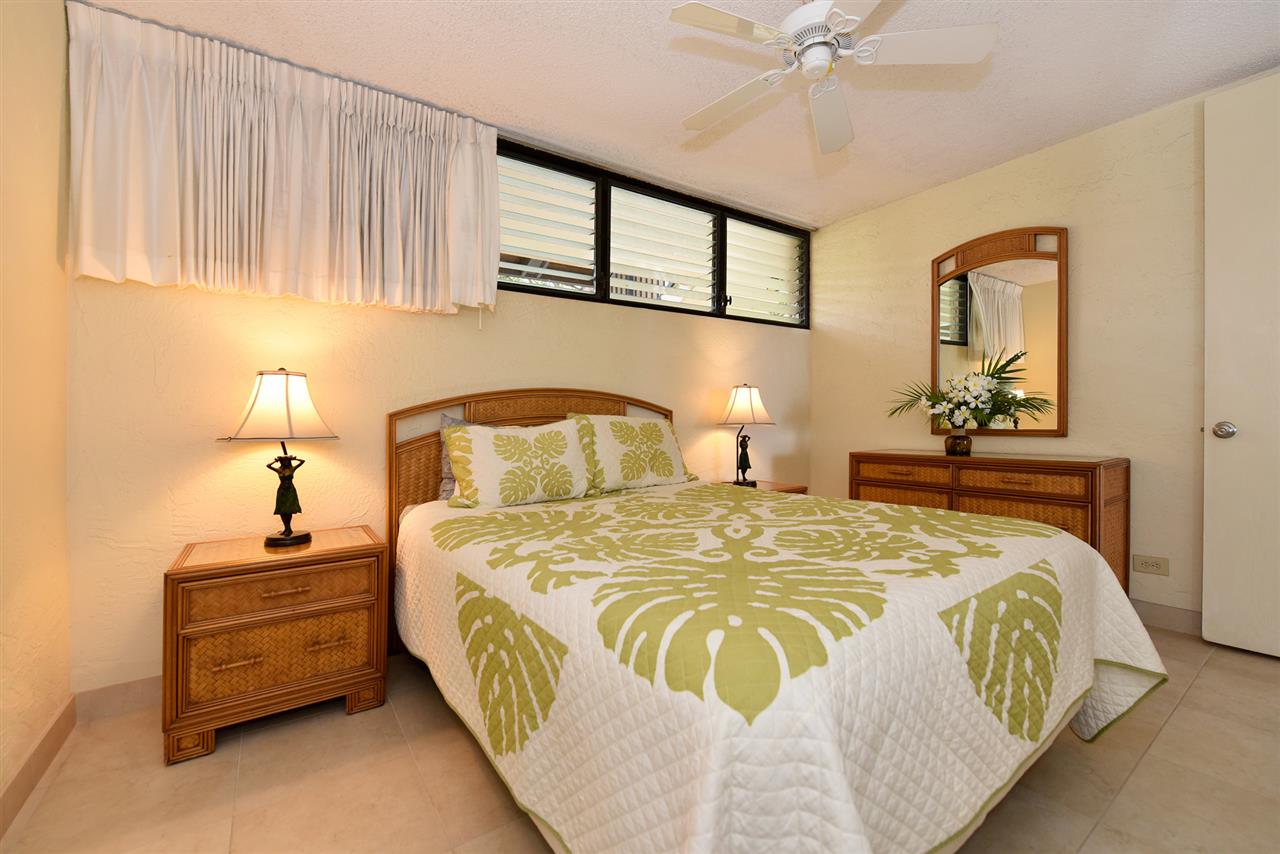 3543 Lower Honoapiilani Road, Unit L302 Lahaina, HI 96761 - Photo 21 of 28 a bedroom with a bed and a chandelier
