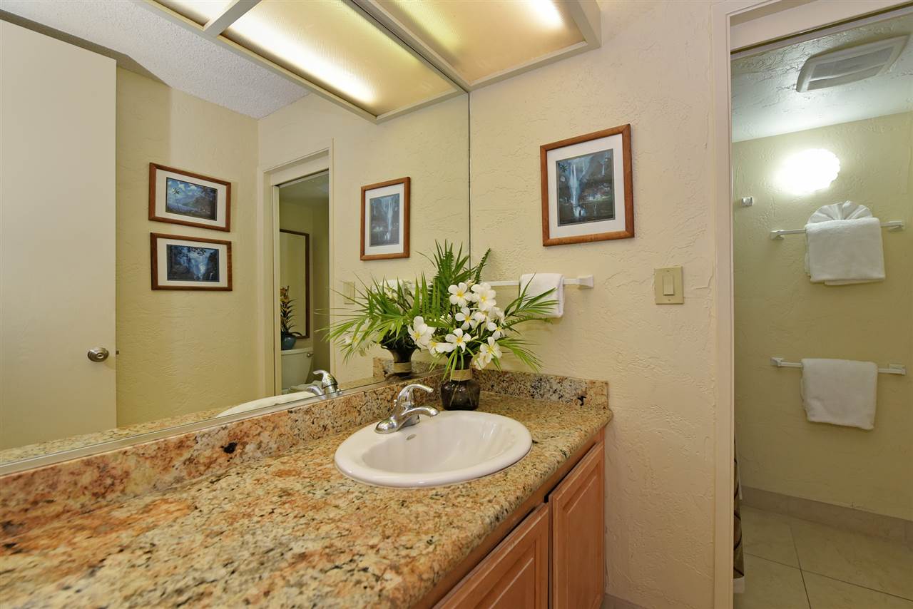 3543 Lower Honoapiilani Road, Unit L302 Lahaina, HI 96761 - Photo 22 of 28 a bathroom with a granite countertop sink and a mirror