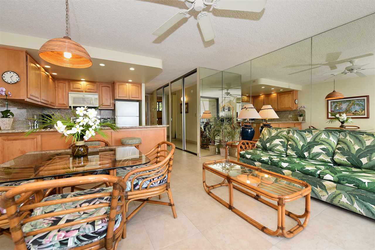3543 Lower Honoapiilani Road, Unit L302 Lahaina, HI 96761 - Photo 25 of 28 a living room with furniture and a chandelier
