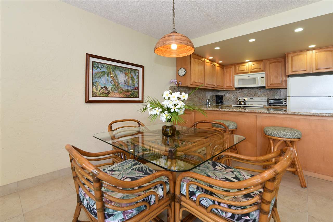 3543 Lower Honoapiilani Road, Unit L302 Lahaina, HI 96761 - Photo 3 of 28 a dining room with furniture and chandelier