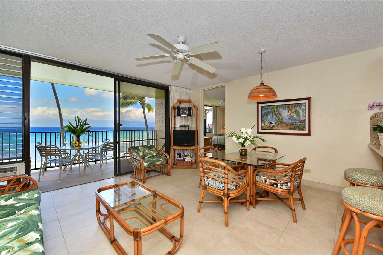 3543 Lower Honoapiilani Road, Unit L302 Lahaina, HI 96761 - Photo 7 of 28 a living room with furniture a lamp and a large window