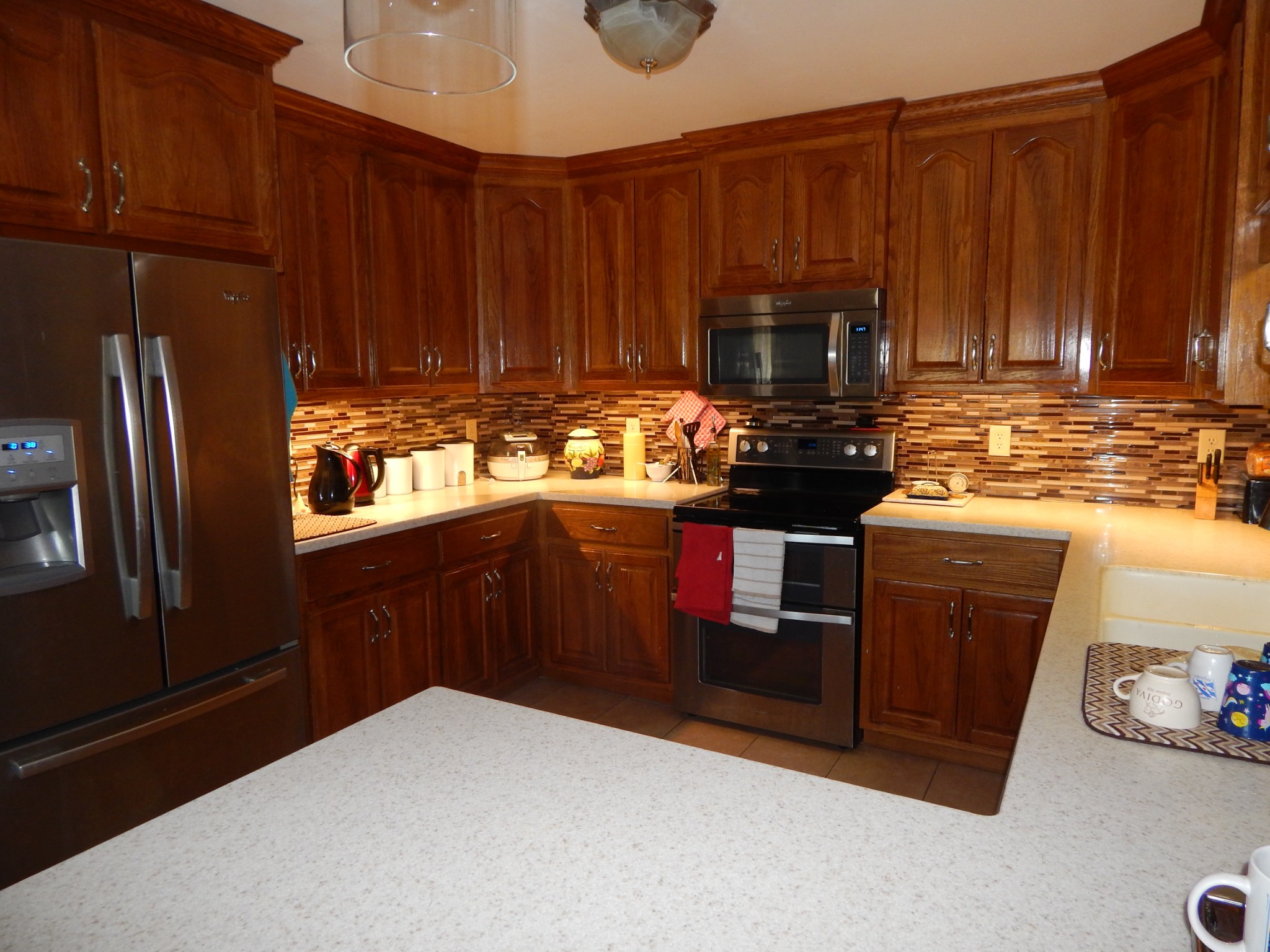 19 Power Station Road Taft, TN 38488 - Photo 3 of 16 a kitchen with wooden cabinets and a stove top oven