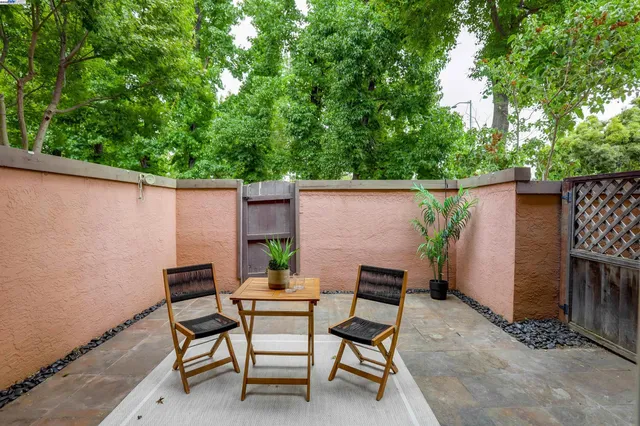 a backyard of a house with table and chairs