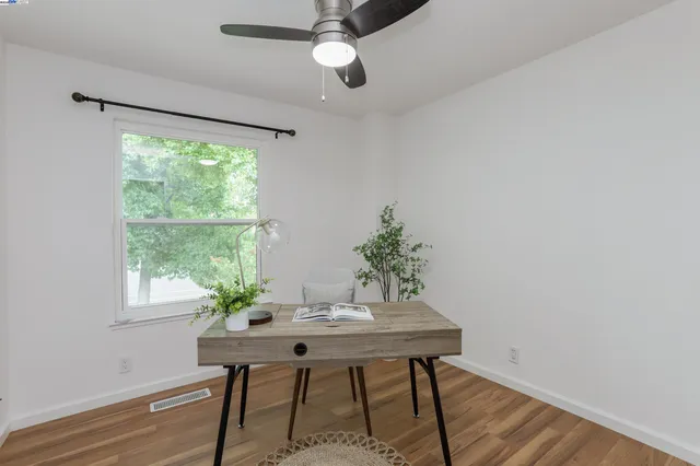 a view of a dining room with furniture window and wooden floor