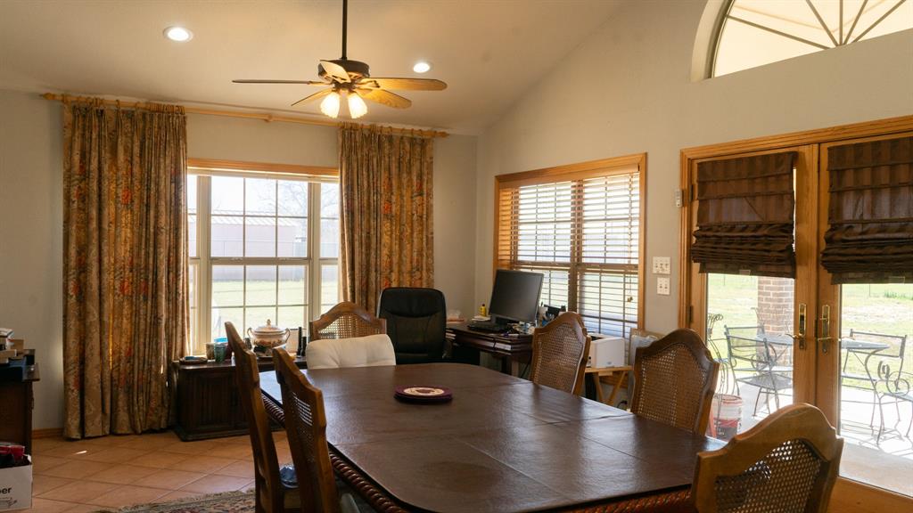 140 Baize Road Abilene, TX 79602 - Photo 12 of 37 Dining room with plenty of natural light, recessed lighting, ceiling fan, lofted ceiling, and french doors