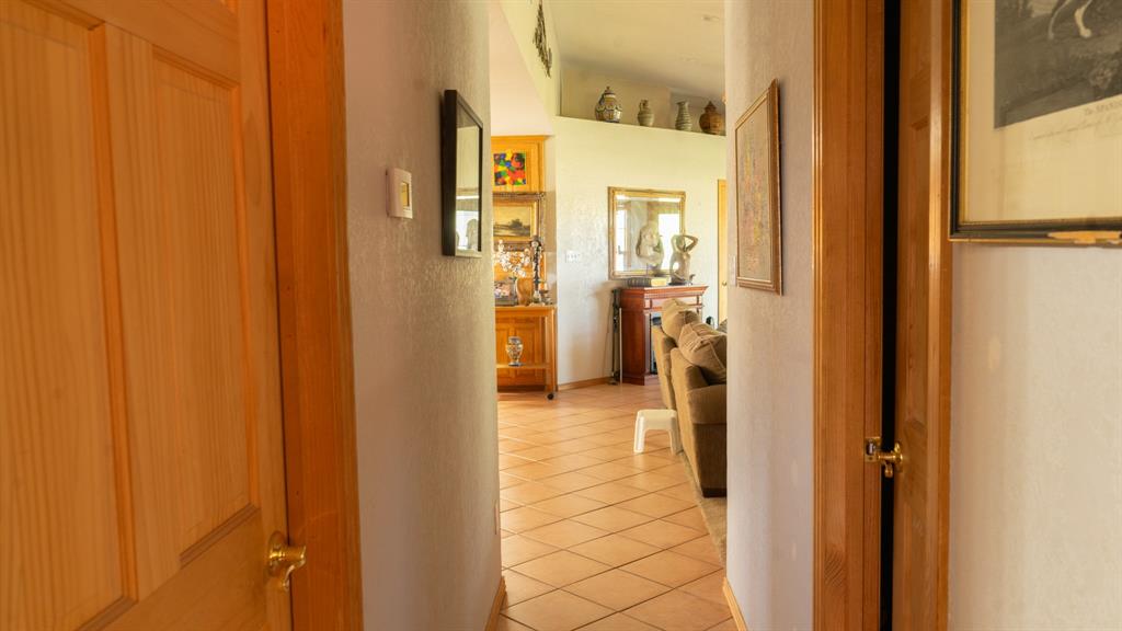 140 Baize Road Abilene, TX 79602 - Photo 16 of 37 Hallway with light tile patterned floors and a textured wall